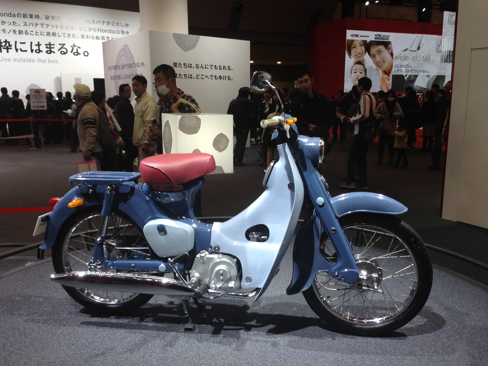An original blue and white Honda C100 displayed at the Tokyo Motor Show in 2013